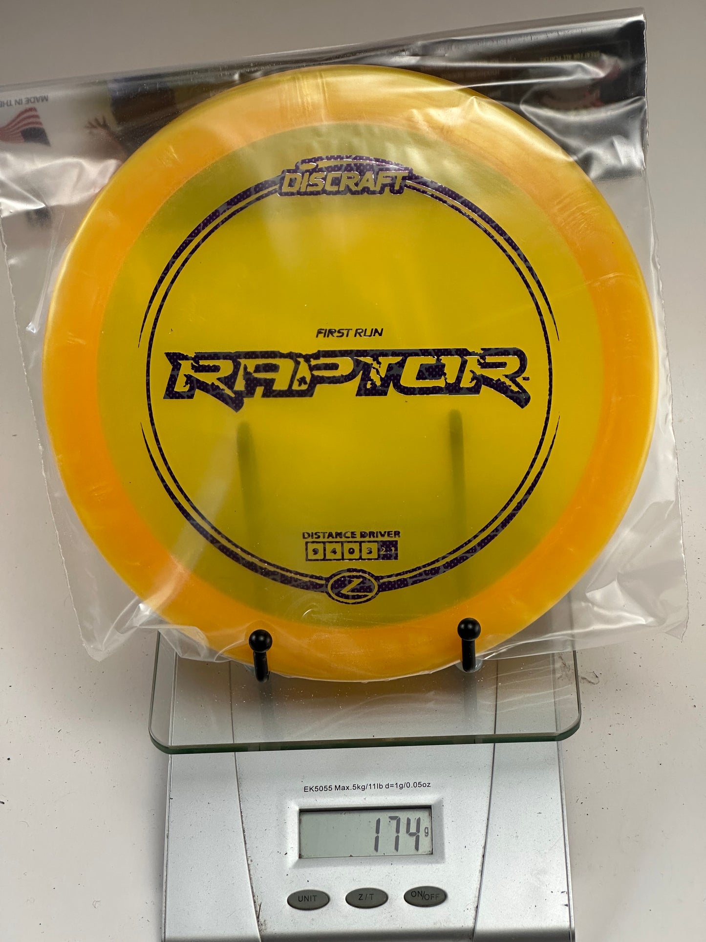Discraft Z Raptor First Run Distance Driver – Clear Yellow/Orange Rim