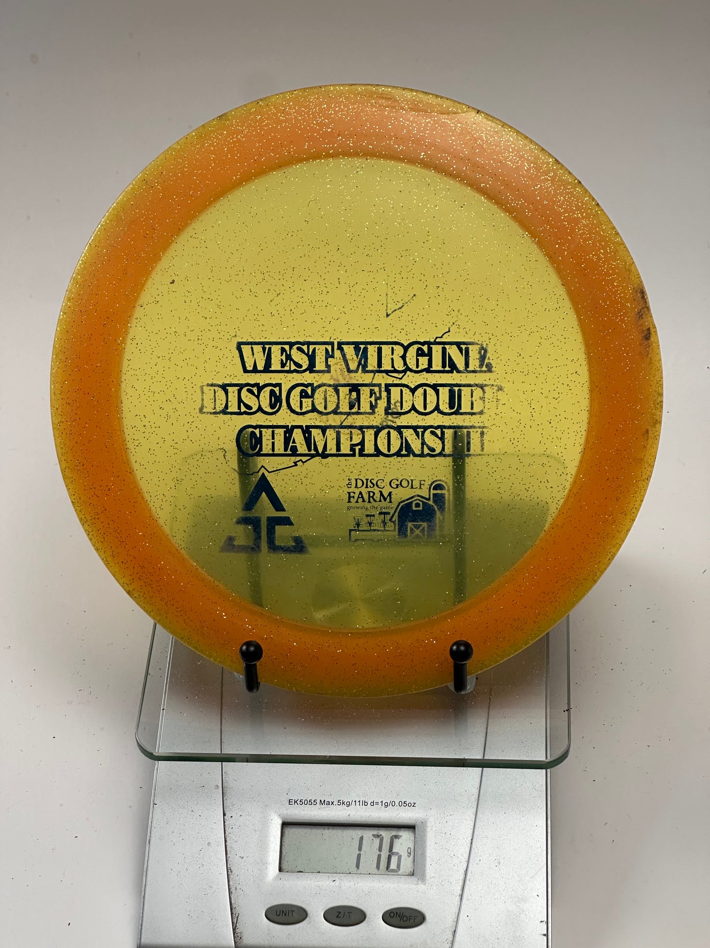 Innova Ape Champion Glow (Glo) Sparkle Orange Rim Yellow Center - Tournament Stamp
