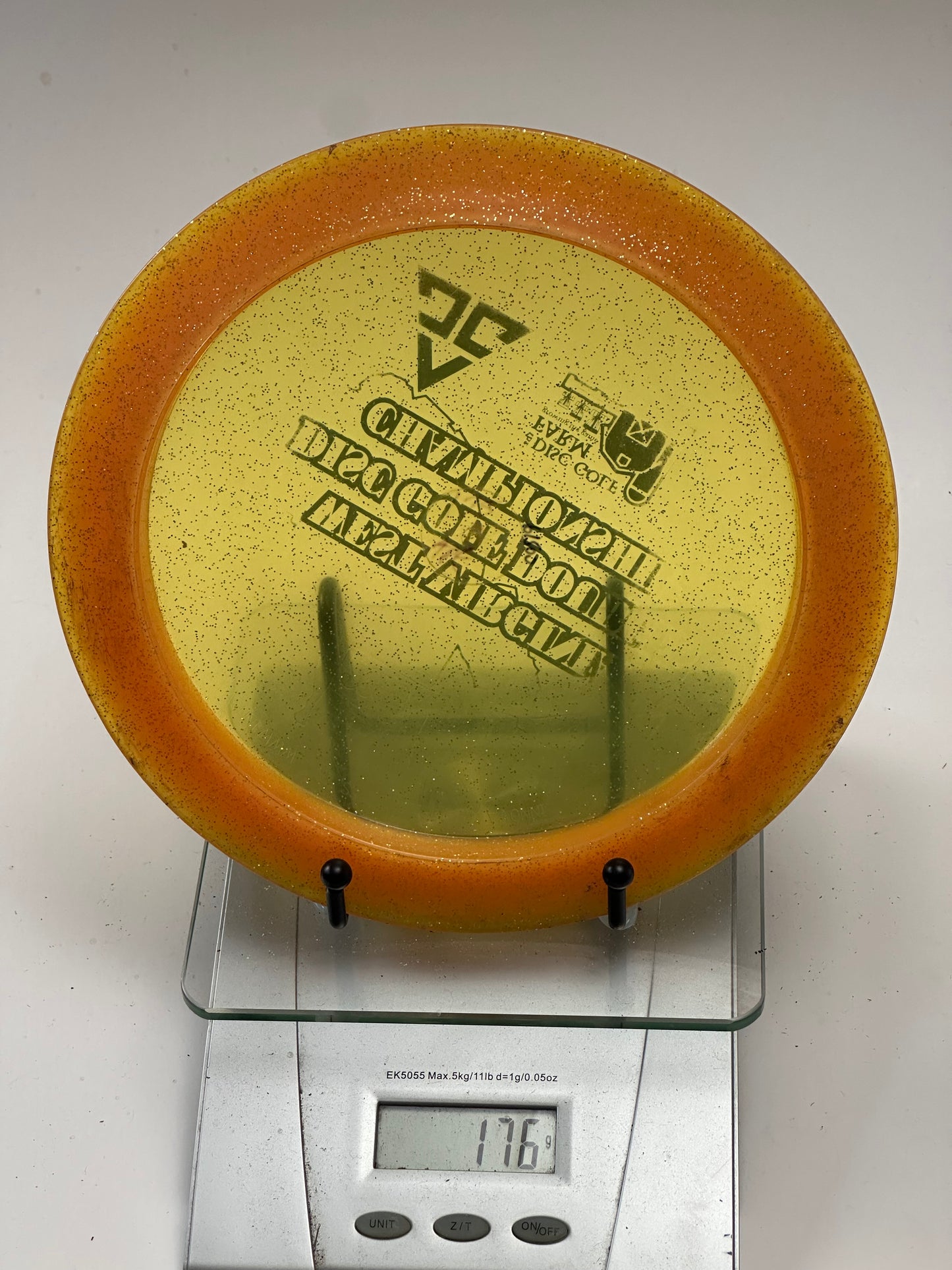 Innova Ape Champion Glow (Glo) Sparkle Orange Rim Yellow Center - Tournament Stamp