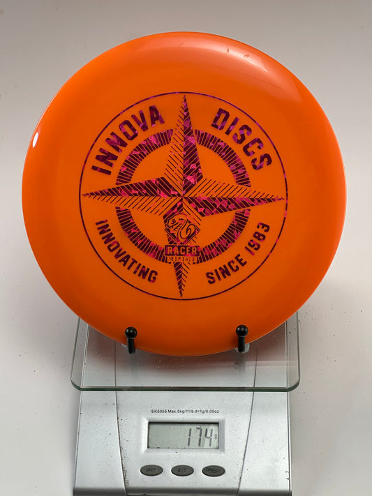 Innova Champion Racer – Orange w/ Pink Shatter Compass Stamp (174g)