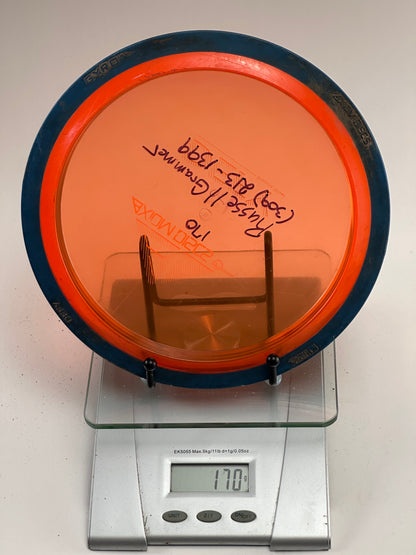 Axiom Defy Proton Distance Driver 170g Orange Transparent w/ Blue Rim
