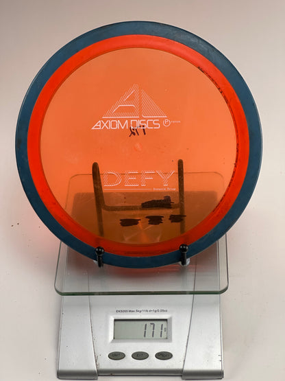 Axiom Defy Proton Distance Driver 171g Orange Transparent/Blue Rim