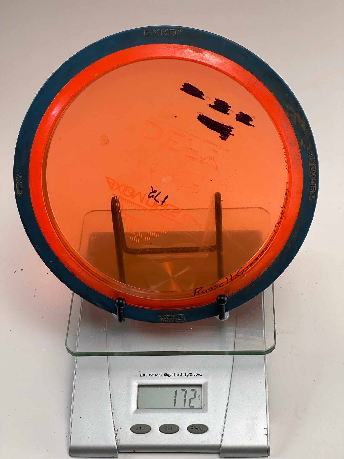 Axiom Defy Proton Distance Driver 171g Orange Transparent/Blue Rim