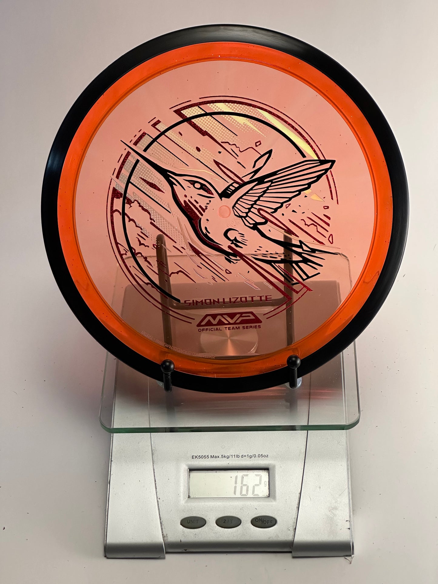 MVP Plasma Tesla Simon Lizotte Team Series (Hummingbird) 162g Orange Clear/Black Rim